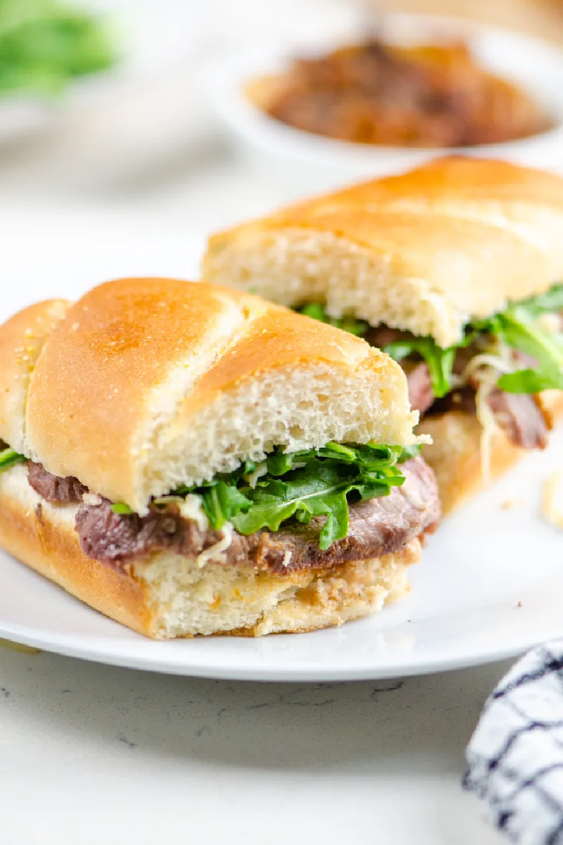 french onion steak sandwiches on white plate