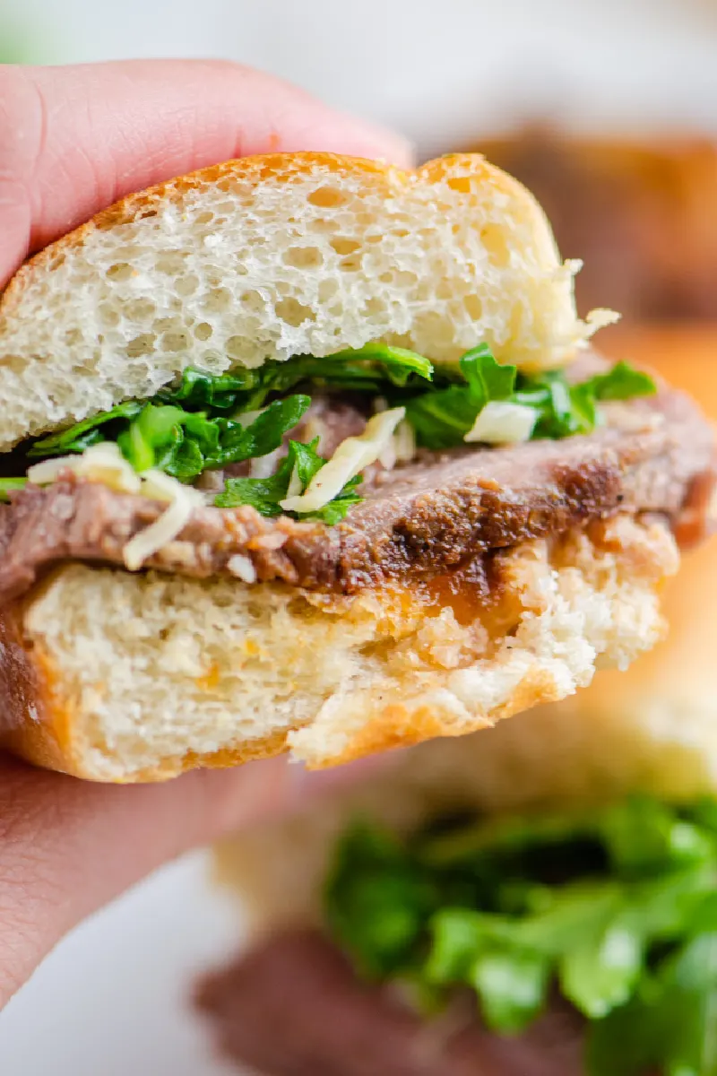 hand holding steak sandwich