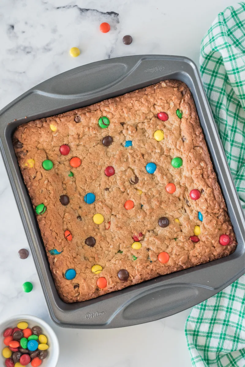 easy monster cookie bars in pan just out of oven