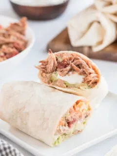 slow cooker pork burrito cut in half