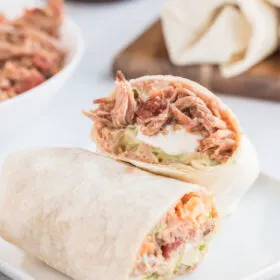 slow cooker pork burrito cut in half