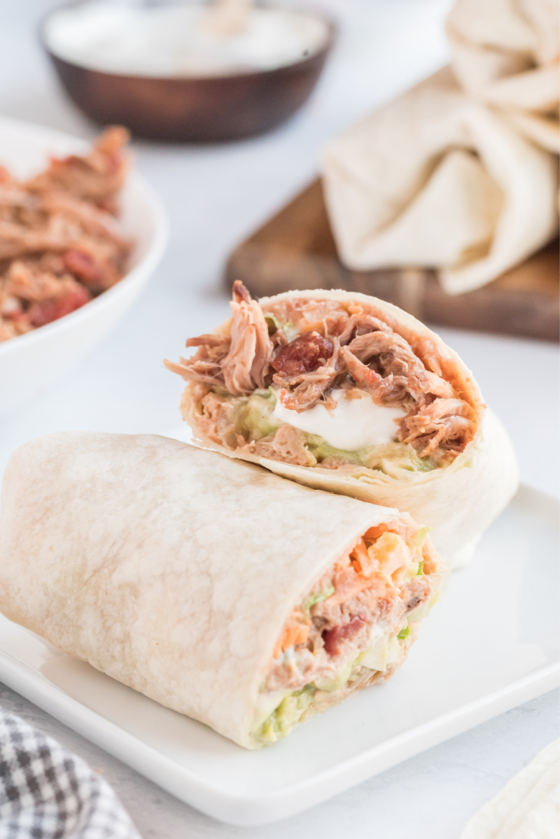 slow cooker pork burrito cut in half