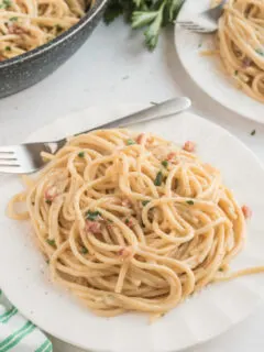 spaghetti carbonara serving on white plate
