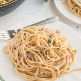 spaghetti carbonara serving on white plate