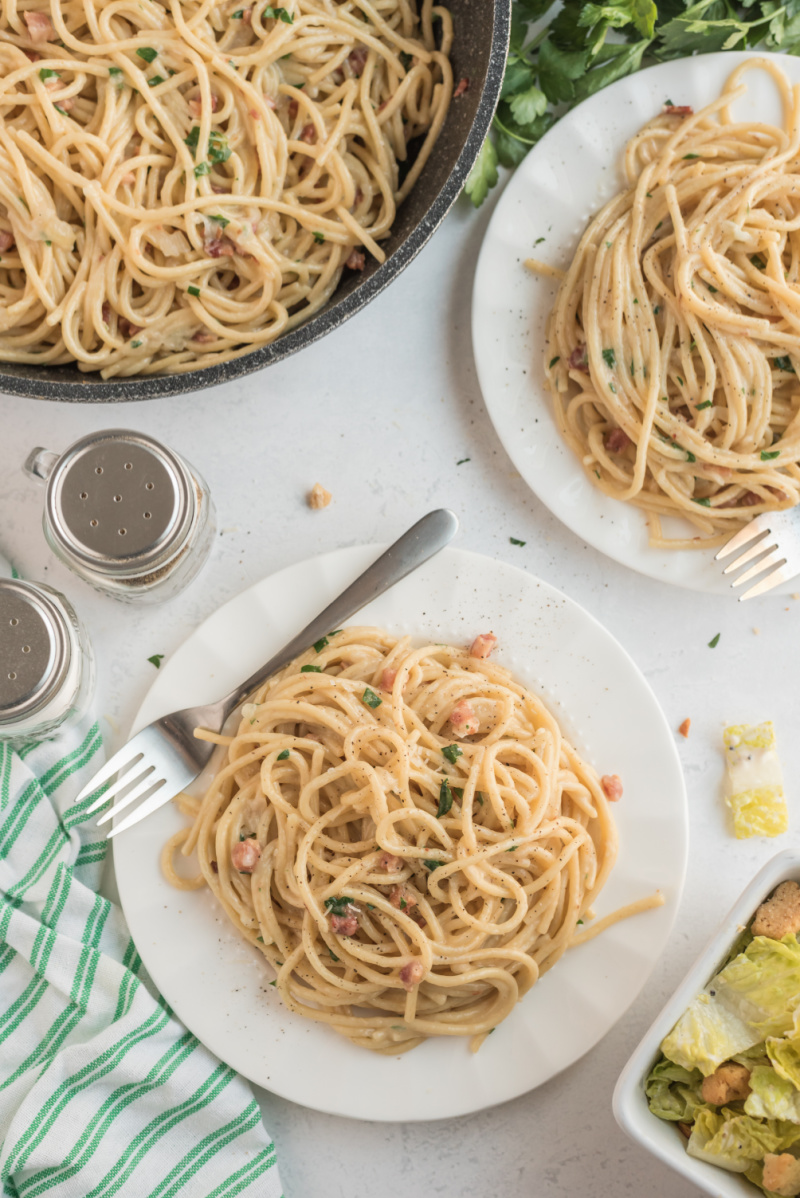 spaghetti carbonara servings on white plates