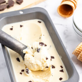 chocolate chunk gelato in a pan with a scoop