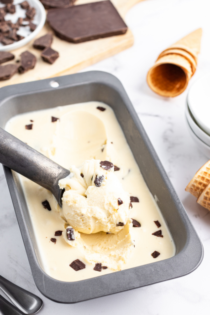chocolate chunk gelato in a pan with a scoop