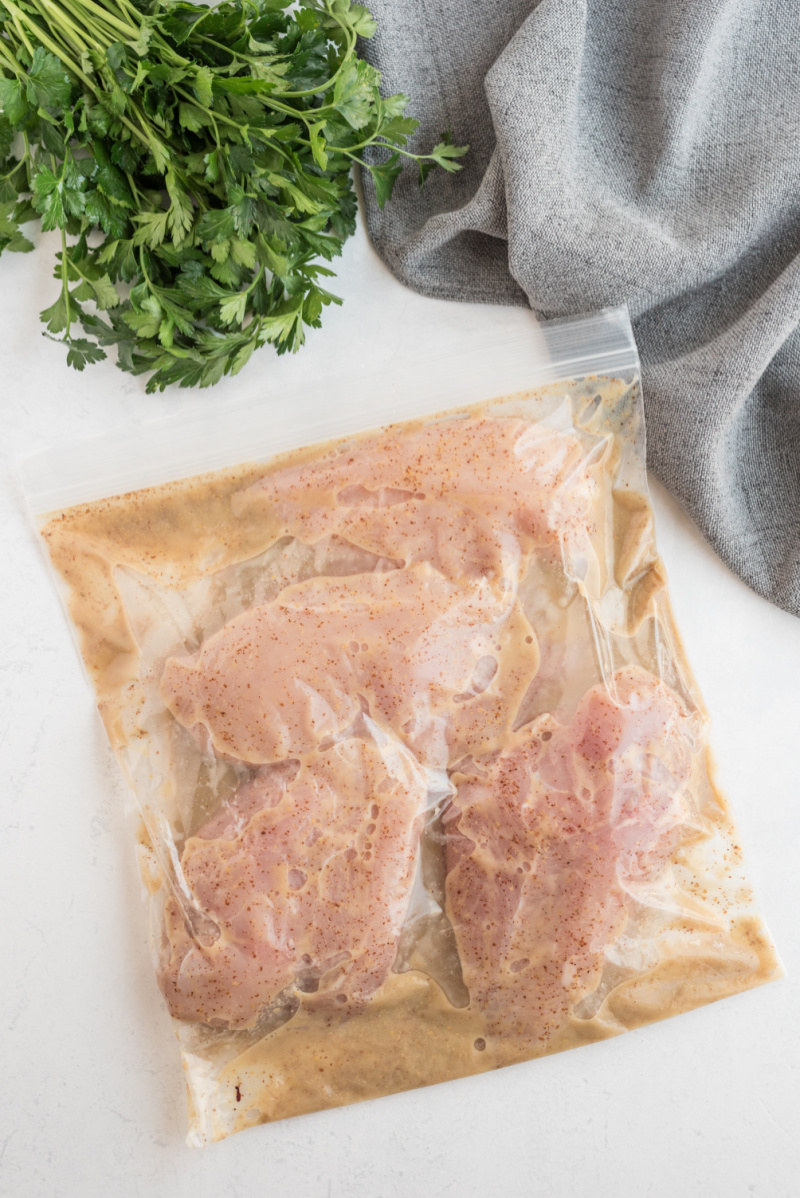 chicken marinating in a bag