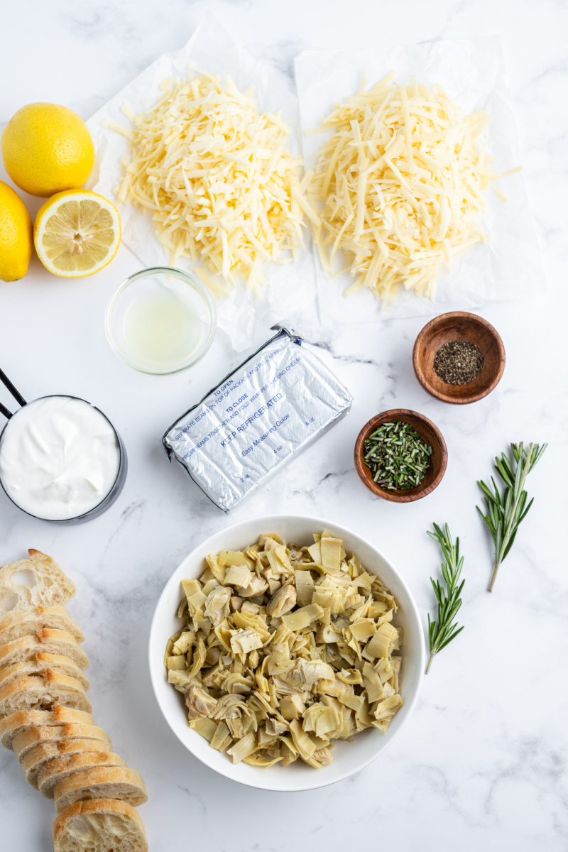 ingredients displayed for making cheesy lemon rosemary artichoke dip