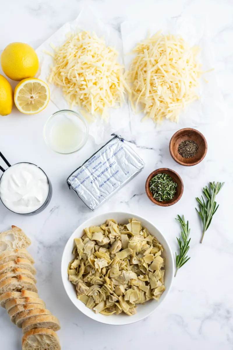 ingredients displayed for making cheesy lemon rosemary artichoke dip