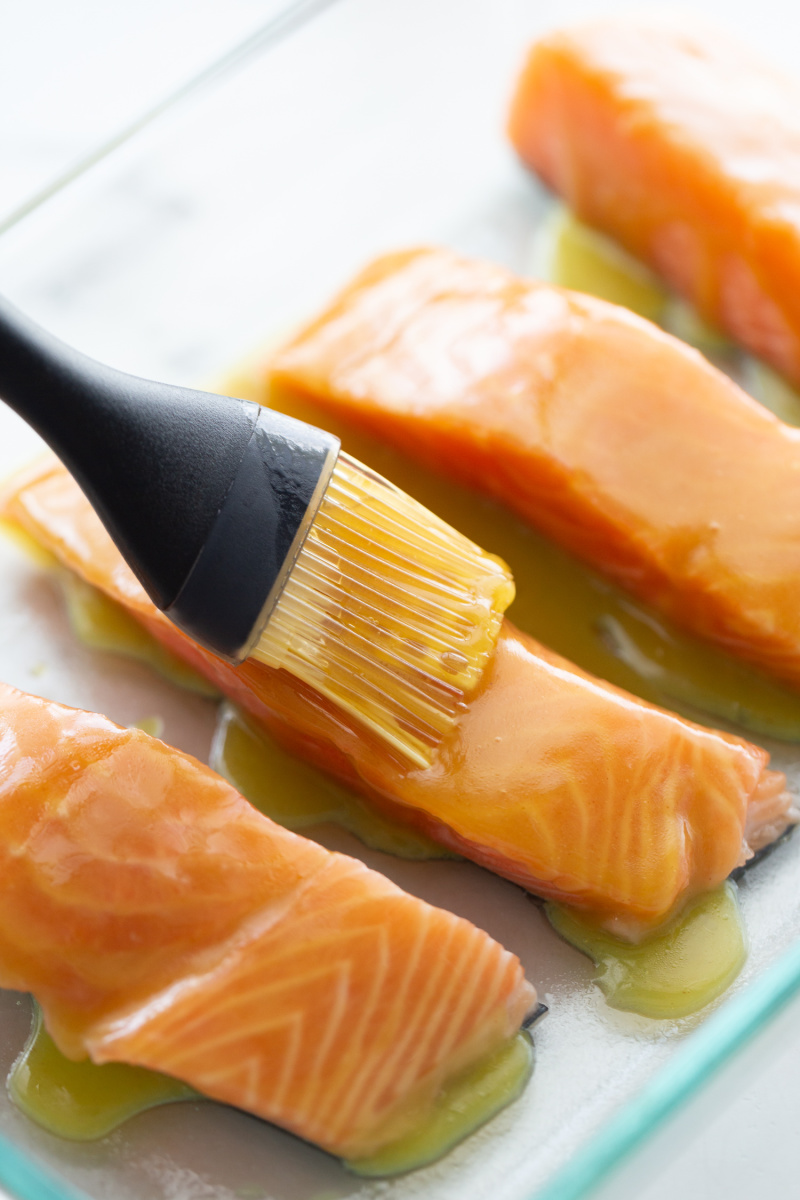 brushing salmon filets with sauce