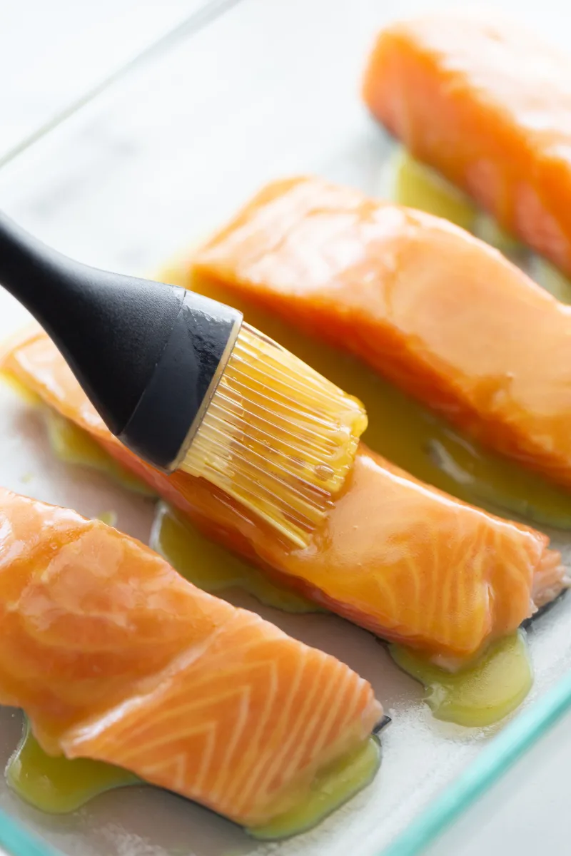 brushing salmon filets with sauce