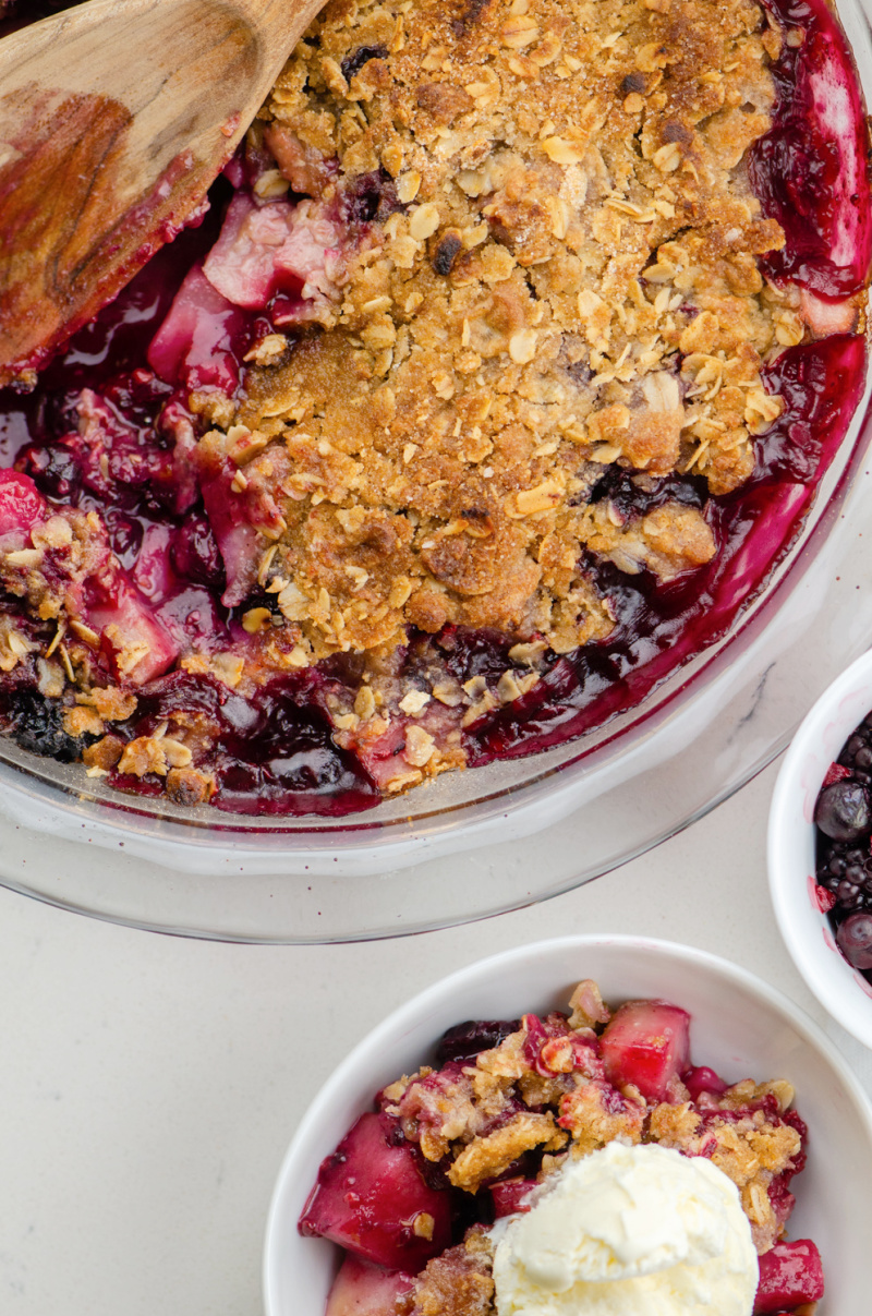 pear and berry crisp and one serving with ice cream beside it