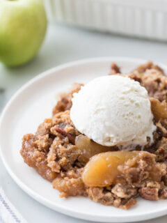 caramel apple dump cake serving with ice cream on top