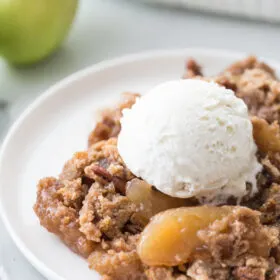 caramel apple dump cake serving with ice cream on top