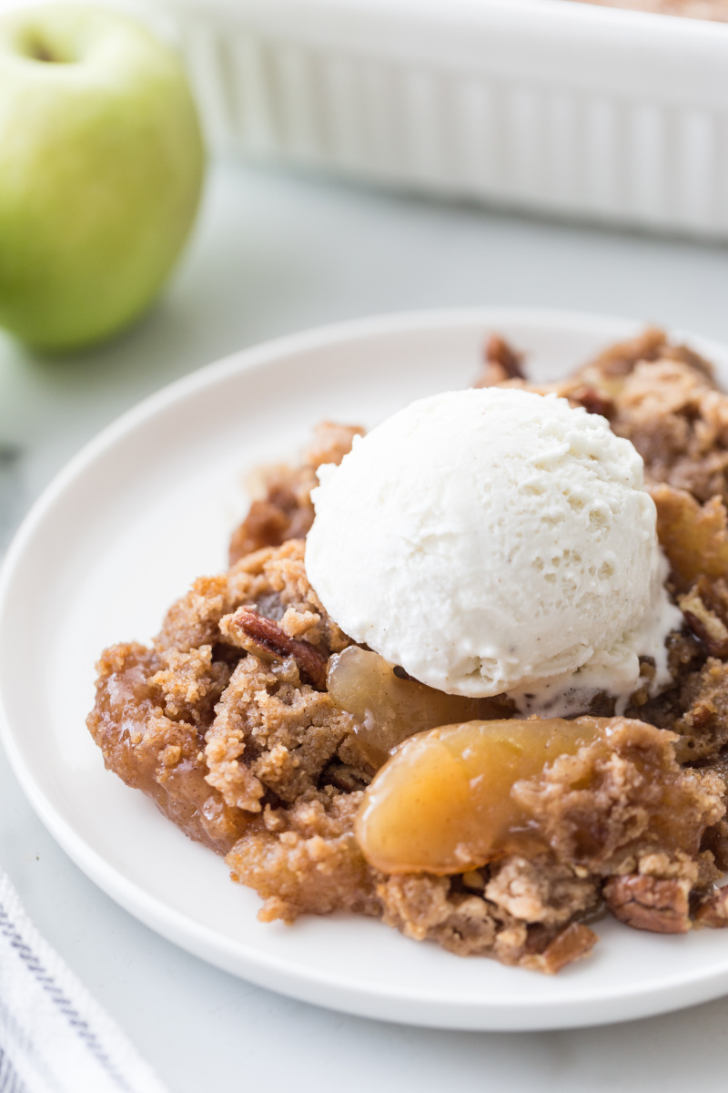 caramel apple dump cake serving with ice cream on top