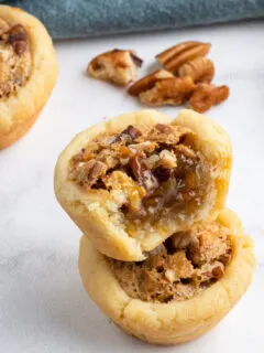 pecan tassies one bite out to show inside.