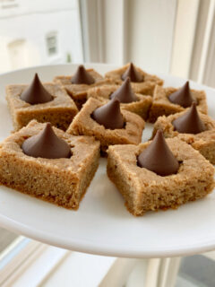 peanut butter blossom bars on a white plate