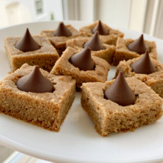 peanut butter blossom bars on a white plate