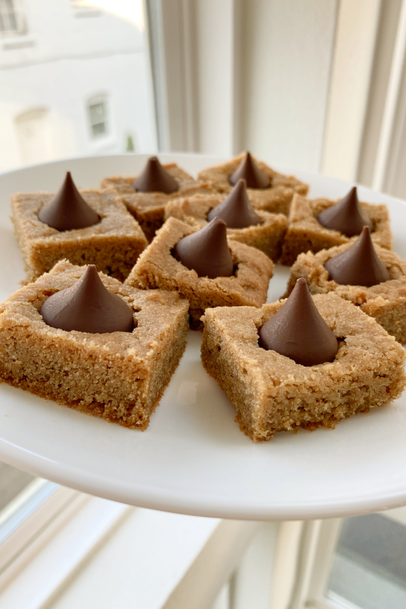 peanut butter blossom bars on a white plate
