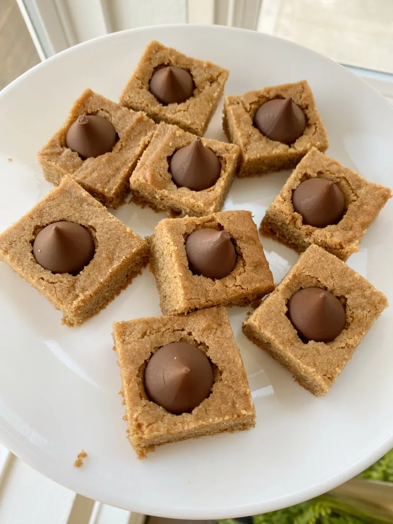 peanut butter blossom bars on a white plate