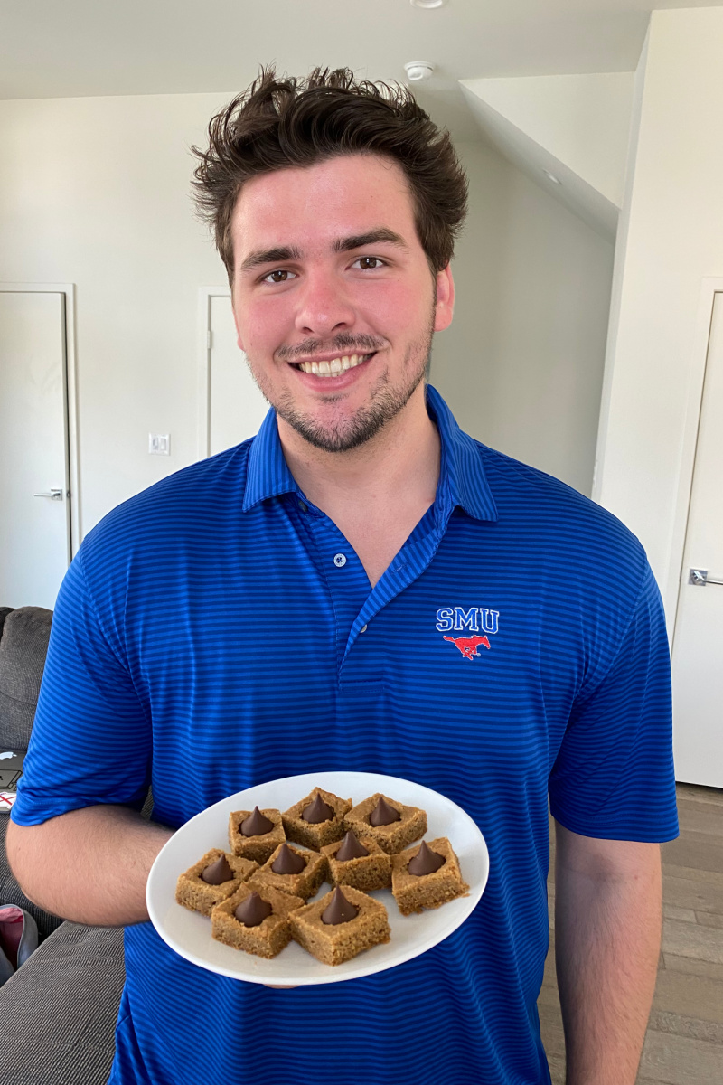 recipeboy holding peanut butter blossom bars