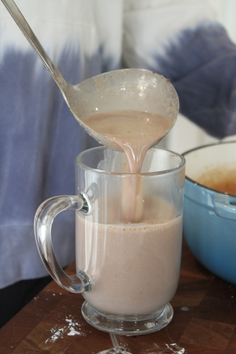 ladling hot chocolate into mug