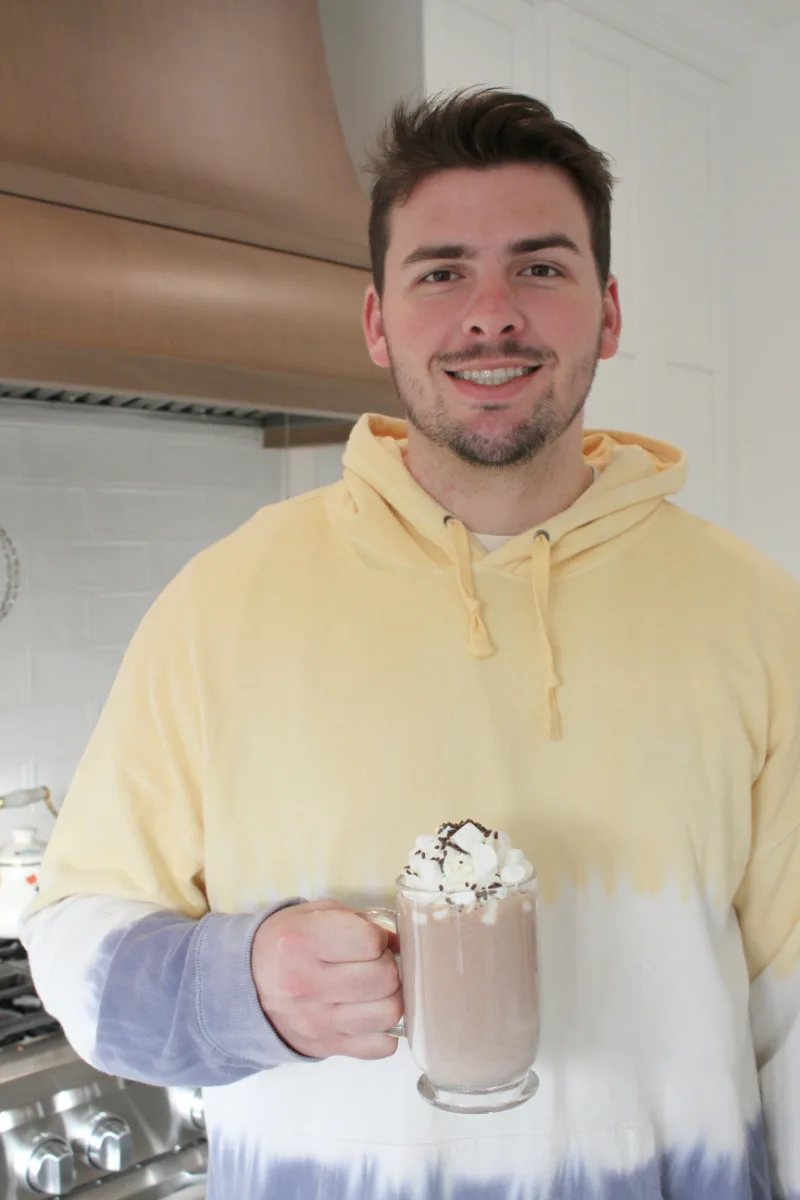 recipeboy holding mug of hot chocolate