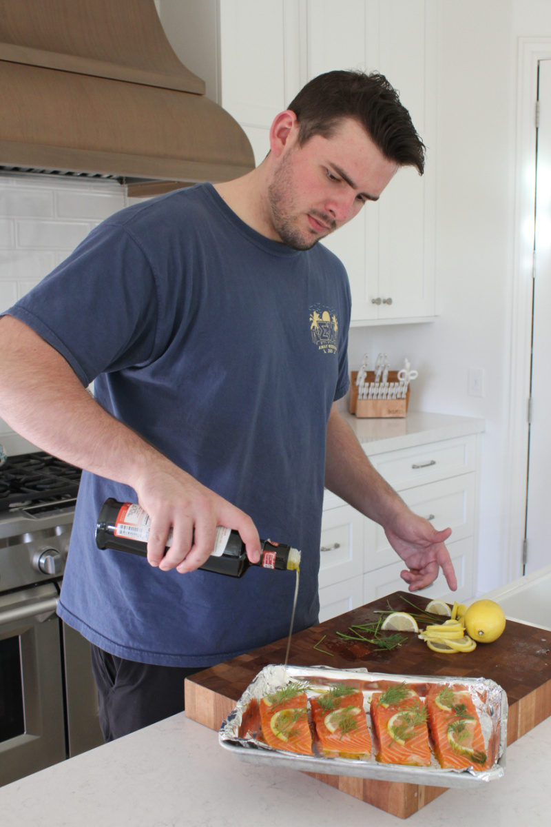 recipeboy pouring olive oil onto salmon