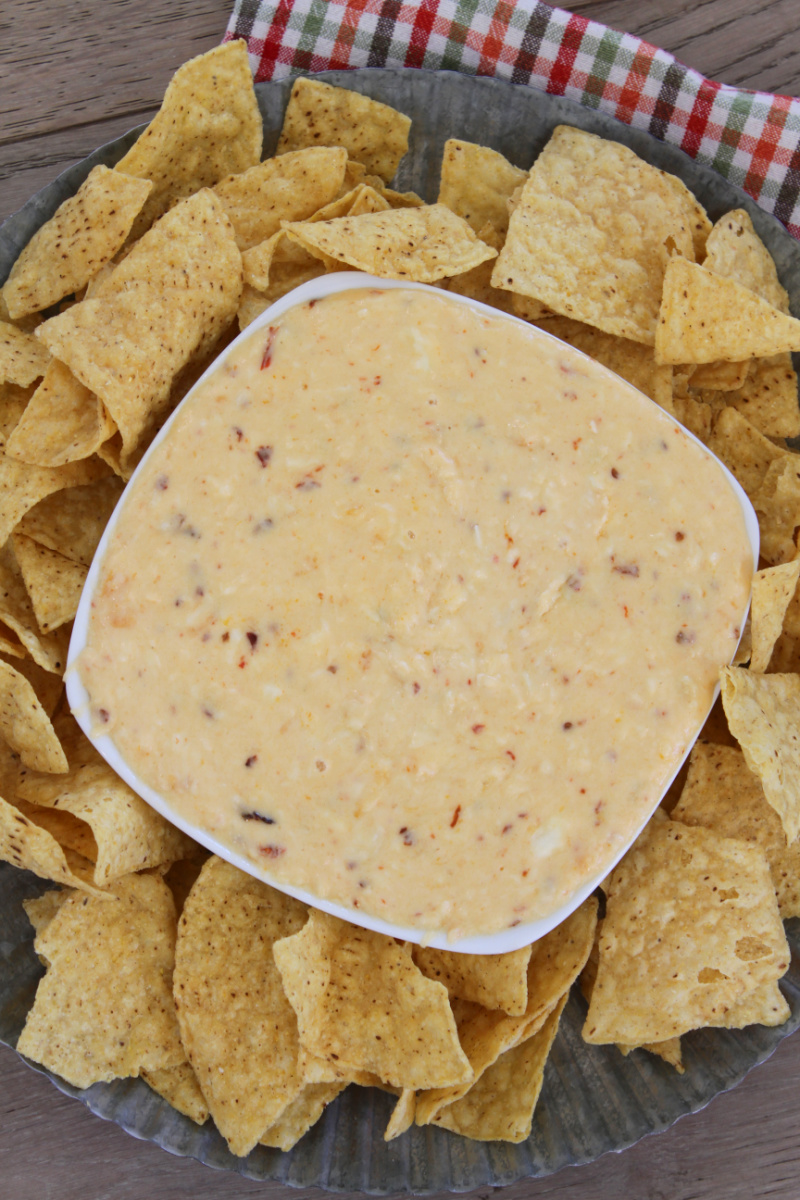 bowl of cheese queso surrounded by chips