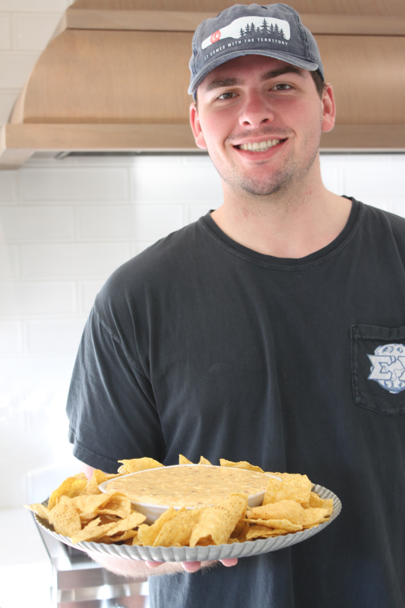 recipeboy holding platter of queso and chips