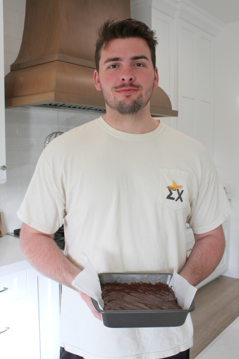 recipeboy holding pan of no bake peanut butter bars