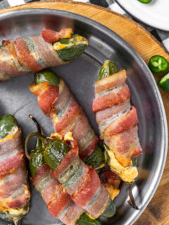 bacon wrapped jalapeno poppers on a plate