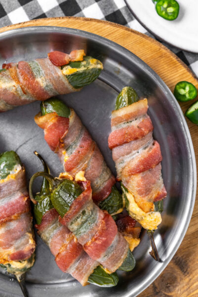 bacon wrapped jalapeno poppers on a plate
