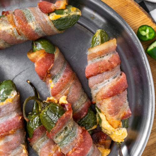 bacon wrapped jalapeno poppers on a plate