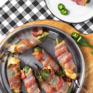 bacon wrapped jalapeno poppers on a plate