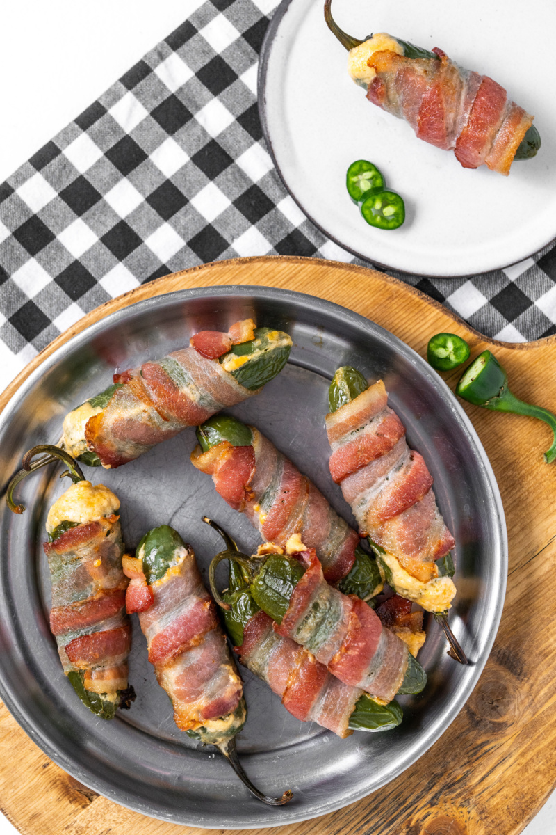 bacon wrapped jalapeno poppers on a plate