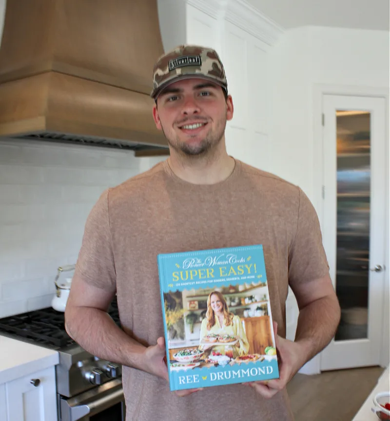 recipeboy holding pioneer woman's new cookbook