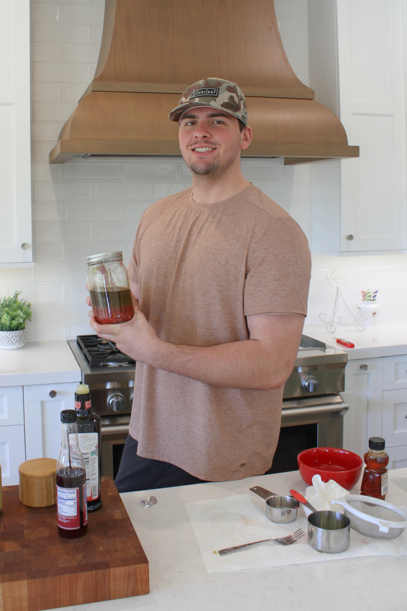 recipeboy holding jar of salad dressing