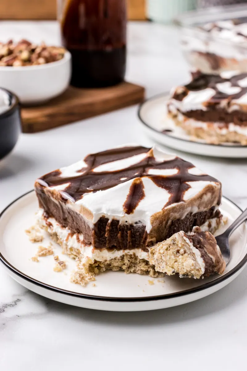 slice of chocolate delight on a plate with bite taken out of it