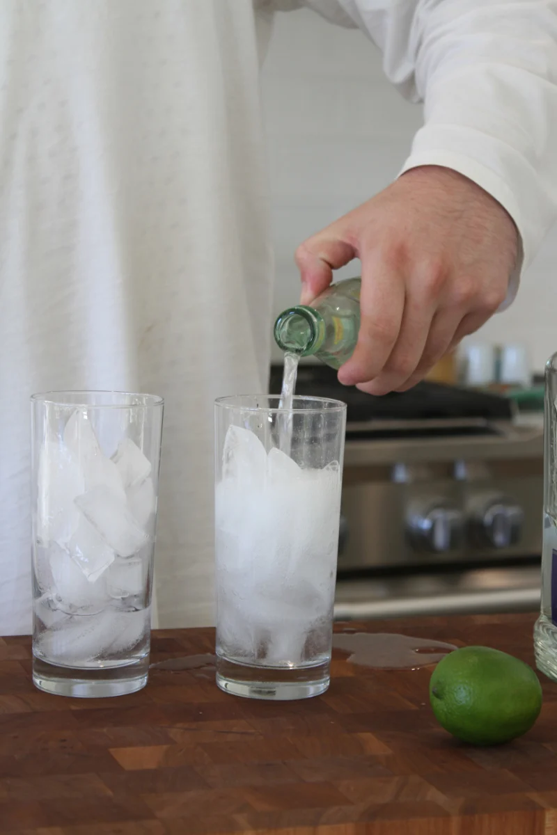 pouring topo chico into glasses