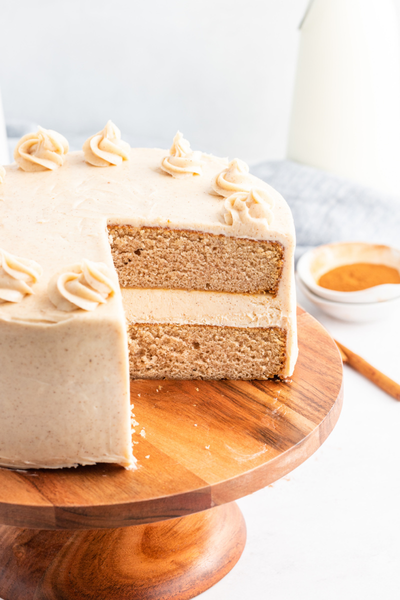 snickerdoodle cheesecake cake with a big slice taken out of it