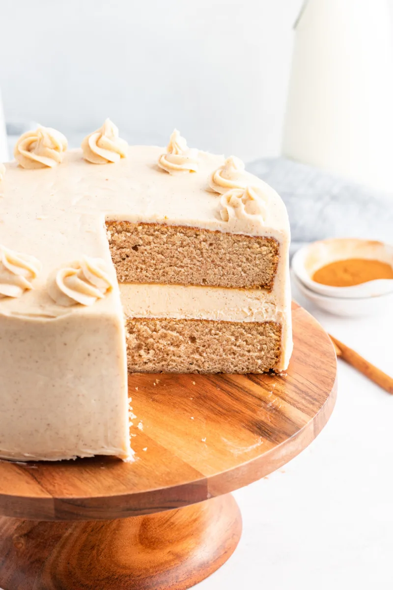 snickerdoodle cheesecake cake with a big slice taken out of it