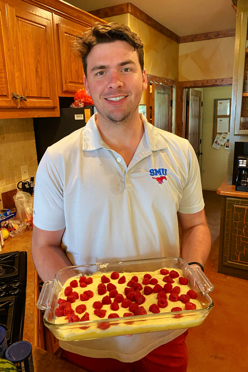 recipeboy holding raspberry gooey butter cake ready for oven