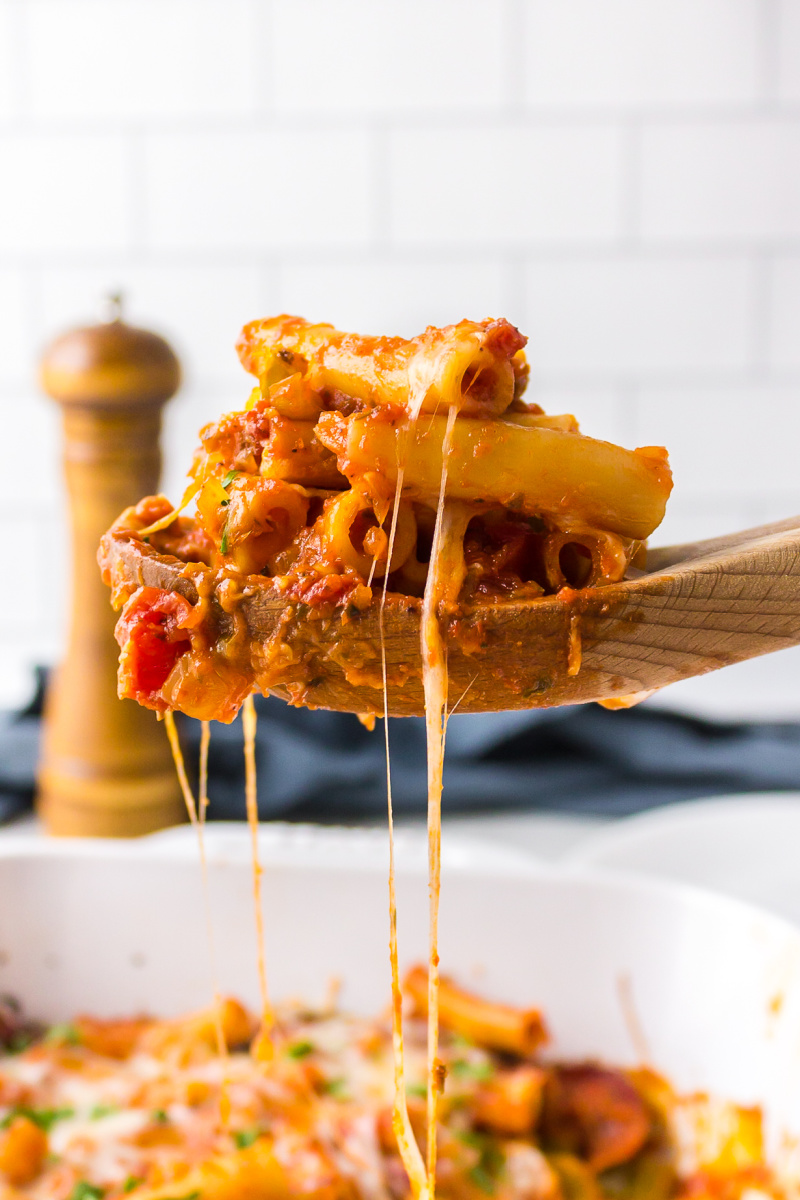 spoon picking up cheesy string of pizza casserole