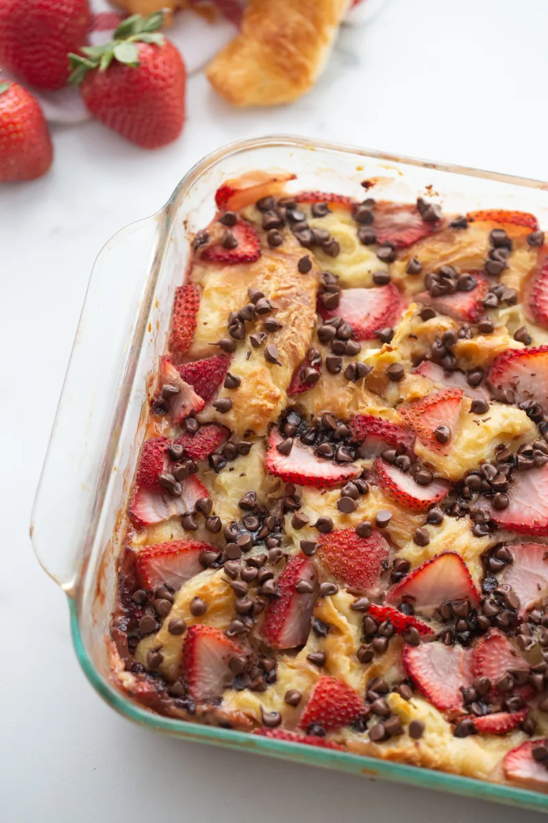 strawberry chocolate chip croissant pudding in a baking dish