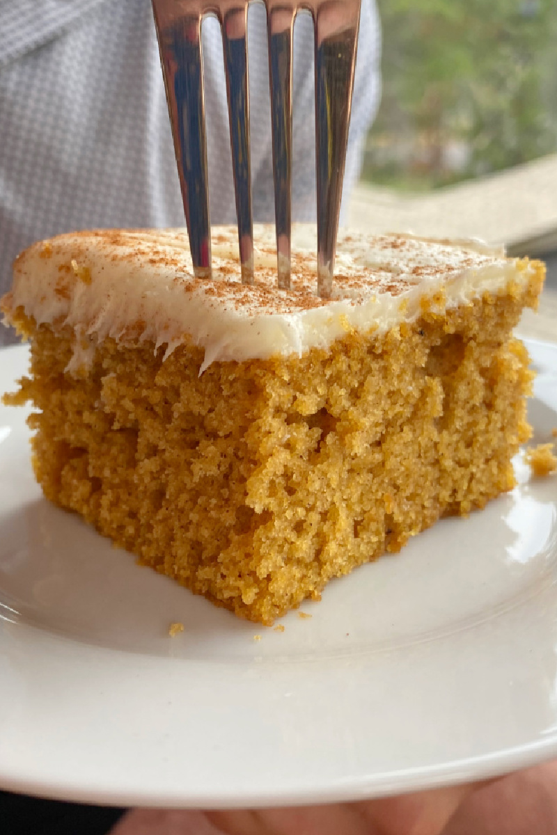 Slice of pumpkin sheet cake with a fork