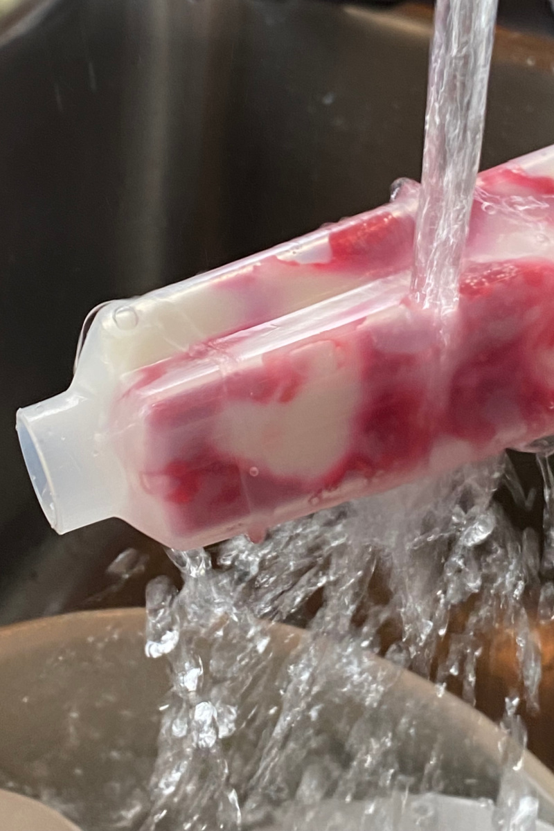 water streaming over popsicle holder