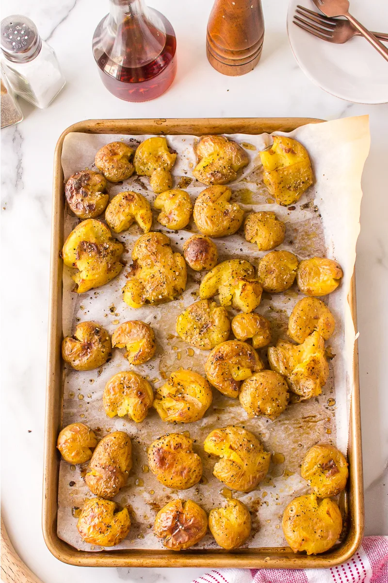 salt and vinegar smashed potatoes on a baking sheet