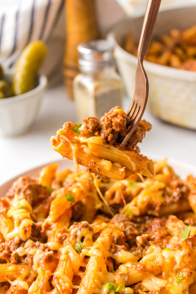 fork full of pasta over a plate